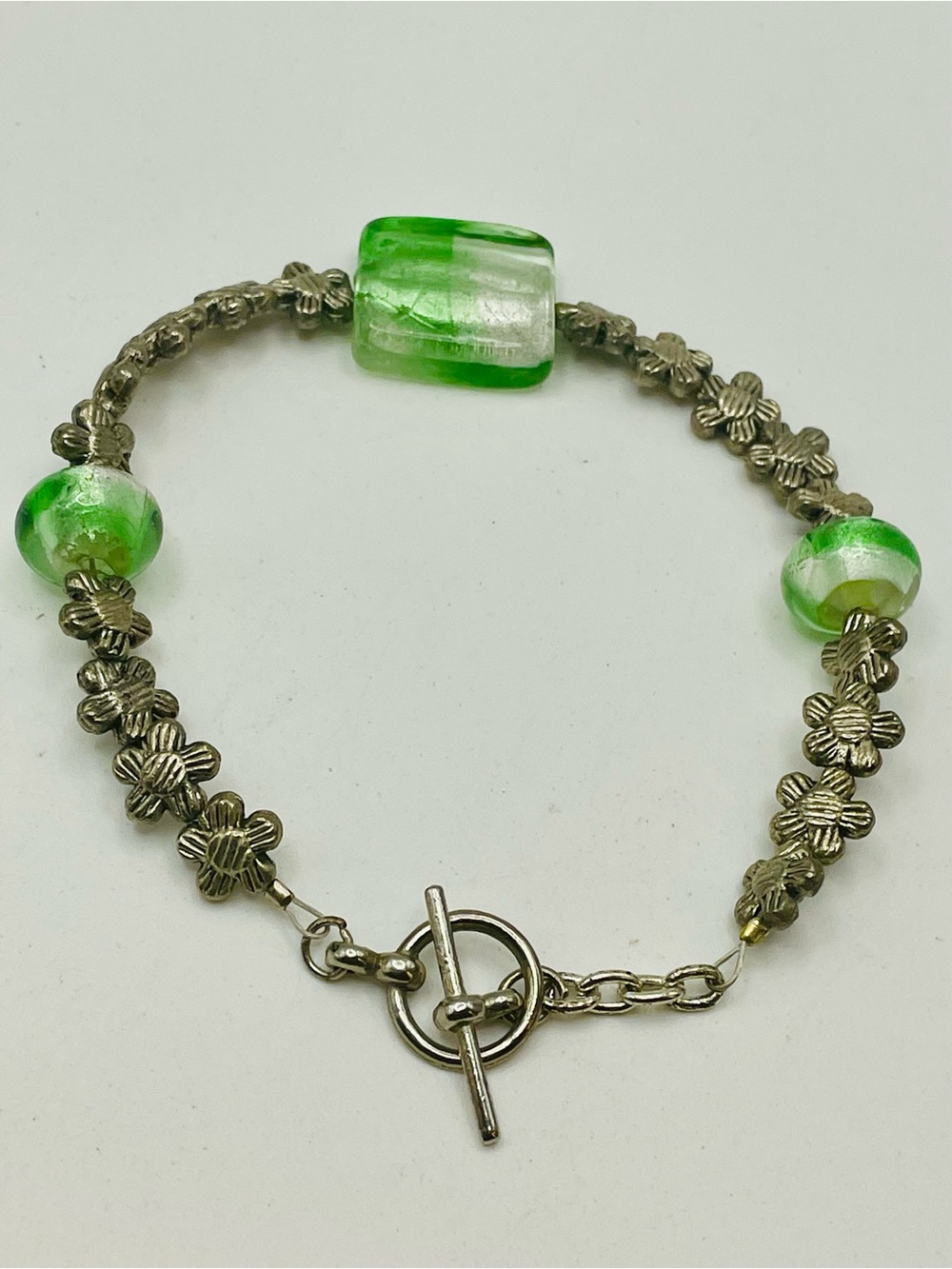 Silver Tone Floral Chain Bracelet w/ Green Glass Beads. Toggle closure. 7 3/4 in